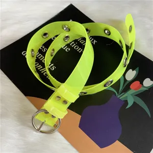 Neon yellow transparent PVC belt detail, metal grommets and round buckle, fashion accessory.