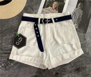 Detail view of white denim shorts with trendy canvas belt and hexagonal buckle design.