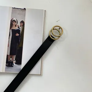Close-up detail shot of the retro black leather belt featuring golden double ring buckle.