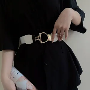 White elastic wide belt detail with round gold metal buckle for women dress styling.