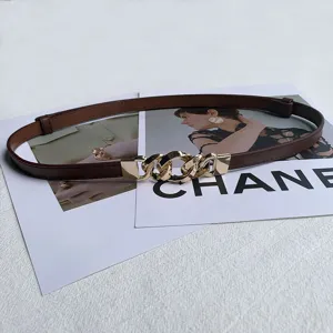 Detail view of women thin leather dress belt with gold chain buckle, adjustable waist strap.