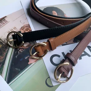 Minimalist thin women's belt with round gold buckle, elegant faux leather strap for jeans.