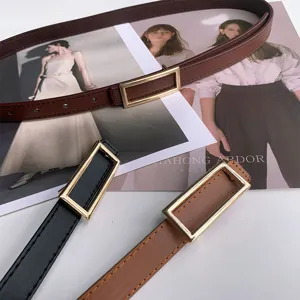 Minimalist thin leather belt with rectangular metal buckle, stylish accessory detail.