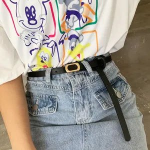 Minimalist black thin belt for women with a sleek gold buckle, perfect for casual outfits.