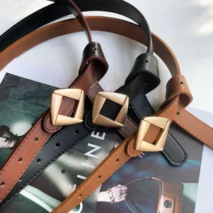 Close-up detail of stylish women leather belts with geometric buckles, multi-color display.