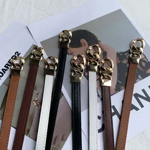 Detail view of stylish thin leather belts featuring elegant golden chain buckles for women.