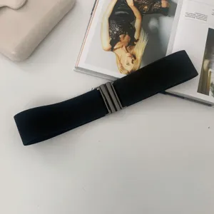 Detail shot of a black elastic waist belt for women, perfect for dresses and coats accessory.