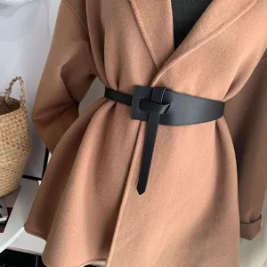 Black leather wide waist belt detail shot, stylish knot design for coat styling and waist shaping.