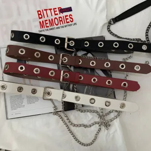 Close-up detail of punk style multi-eyelet leather waist belts with metal chains in four colors.