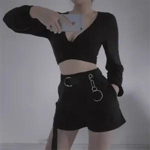 Stylish women streetwear black crop top and cargo shorts set with metallic double ring belt.