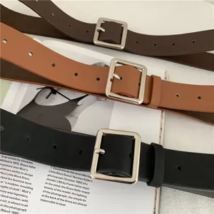 Close-up detail shot of classic square buckle leather belts in three versatile colors.