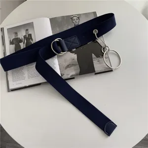 Detail view of a dark blue canvas belt featuring metal double D-rings and hanging rings.