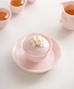 Pink ceramic gaiwan tea cup set with delicate floral lid design for elegant tea time details.