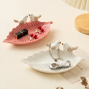 Cute ceramic leaf jewelry tray with little bird figurine, perfect desktop organizer.