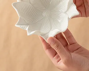 White ceramic flower tray detail view, textured botanical jewelry and key storage dish display.