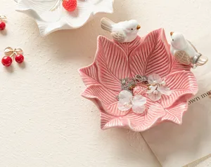 Ceramic pink leaf jewelry tray close-up, cute bird trinket dish detail for home desktop storage.