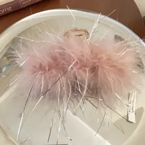 Pink feather hair claw clip with silver tinsel threads, elegant French style accessory for women.
