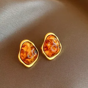 Vintage brown amber geometric earrings with gold border, chic minimalist retro ear studs.