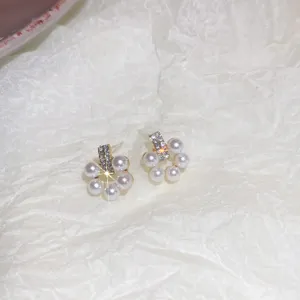 Elegant pearl flower stud earrings with sparkling rhinestones, exquisite detail close-up.