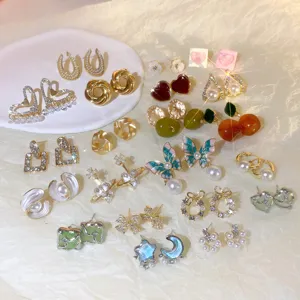 Detailed view of diverse fashion earrings showcasing sparkling crystals and pearls.