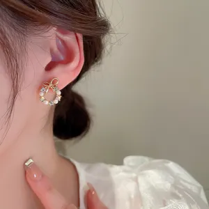 Exquisite french vintage pearl bowknot earrings detail view, elegant jewelry accessory.