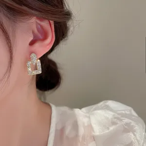 Stunning geometric rhinestone gold earrings for women, sparkling crystal detail close-up view.