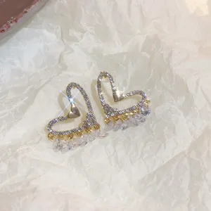 Exquisite crystal paved heart dangle earrings detail, shining rhinestone detail close up.