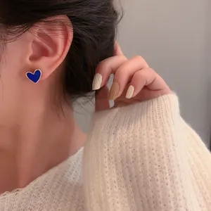 Blue heart stud earrings detail view, showing exquisite metal edge and chic everyday style.