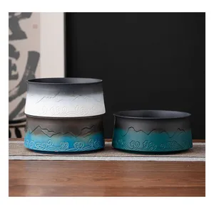 Japanese Zen style ceramic tea wash basin with mountain and wave relief design for tea lovers.