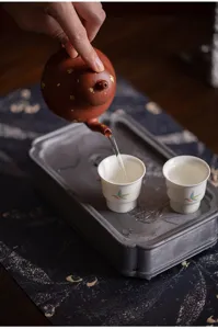 Retro kung fu tea set with ceramic teapot, delicate tea cups and vintage tea tray for ceremony.