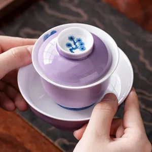 Handmade purple ceramic gaiwan tea set with delicate blue pine tree motif for kung fu tea tasting.
