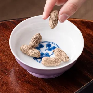 Handcrafted purple ceramic tea saucer with blue pine tree design for tea ceremony.