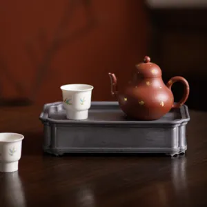 Vintage purple clay teapot and ceramic tea cups set with antique tin tea tray for tea ceremony