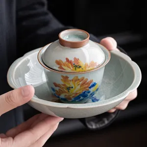 Tasse à thé gaiwan en céramique peinte à la main avec glaçure craquelée et motif pivoine élégant.