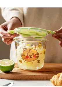 Detail view of the cute tiger glass soup bowl with green lid, microwave safe for daily use.