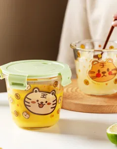 Clear glass lunch box with cute tiger print and green lid, perfect for office meals and food storage.