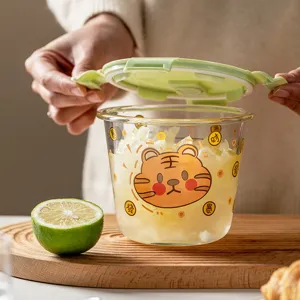 Glass lunch box with cute tiger print, sealed green lid, microwave safe bowl for food storage.