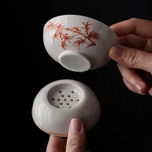 Ceramic tea strainer with red bamboo pattern, traditional Chinese kung fu tea set accessory.