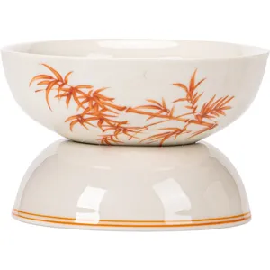 Ceramic tea strainer and holder set featuring traditional red bamboo pattern design.