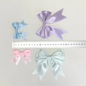 Multi-color satin ribbon bows with size reference ruler, ideal for DIY clothing and hair accessories.