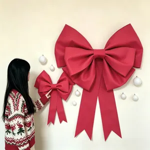 Detail view of large red EVA Christmas bow wall hanging decoration with festive ornaments.