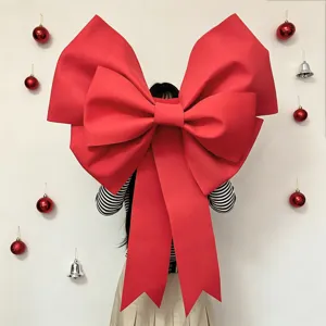 Detailed close-up view of the giant red EVA bow for holiday decoration displayed.