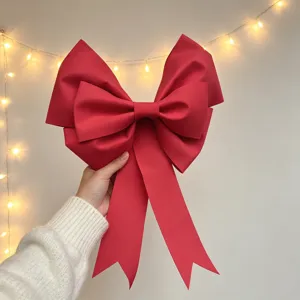 Close-up detail of large red EVA bow Christmas party decoration hanging ornament festival prop.