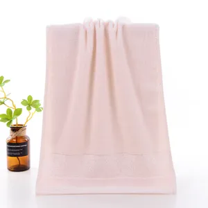 Detailed view of the soft pink cotton face towel with delicate embroidered floral border.