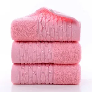 Detailed close-up view of thick soft absorbent pink cotton face towels stacked neatly.