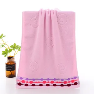 Pure cotton pink face towel with embossed circles and colorful dot border for home daily use.