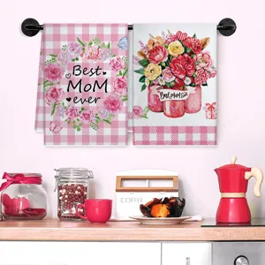 Primo piano di strofinacci da cucina per la festa della mamma a quadri rosa e floreali.