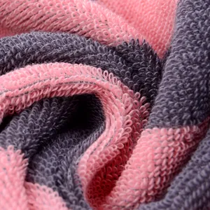 Detailed close-up view of soft pink and dark gray cotton towel loops fabric texture