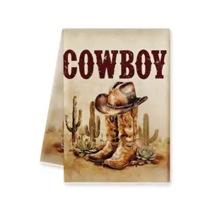 Vue de détail en gros plan du torchon de cuisine imprimé cowboy western avec des cactus.