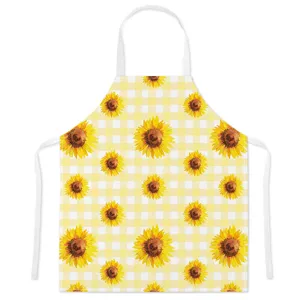 Detailed view of the yellow gingham sunflower kitchen apron, showing watercolor floral print fabric.